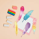 Colorful feather-shaped bookmarks and a rainbow-colored rectangular object on a beige background