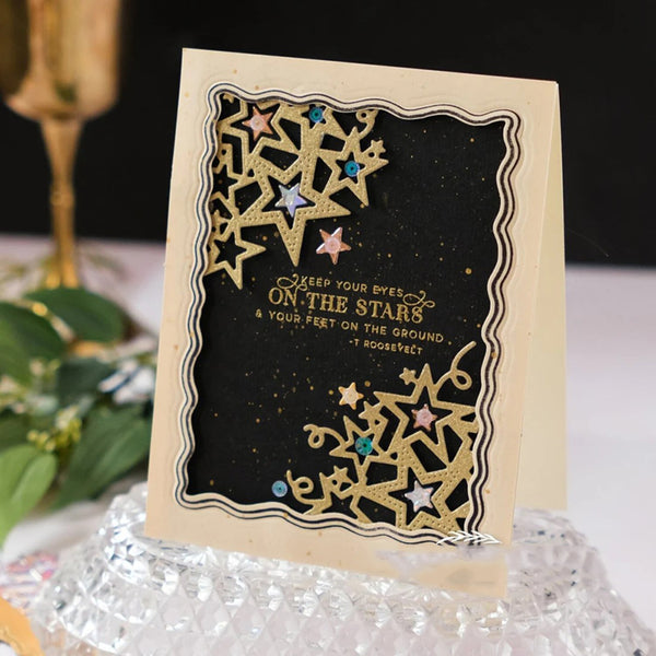 Decorative card with star designs and text on a black background, placed on a textured surface.