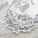 Decorative clear stickers with floral designs and text on a wooden surface