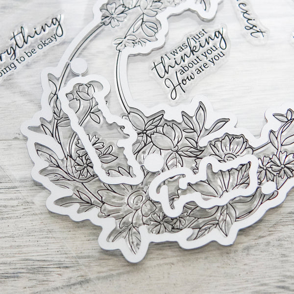 Decorative clear stickers with floral designs and text on a wooden surface