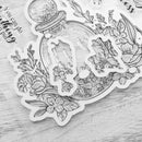 Decorative sticker with floral and nature-themed design on a textured surface