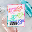 Colorful card with heart designs and text on a marble surface with decorative bottles.