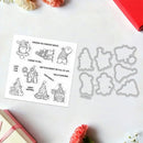 Metal die cut shapes of Christmas-themed figures on a white surface with printed sentiments.