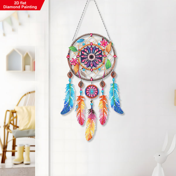 Colorful dreamcatcher with feathers hanging on a white wall.