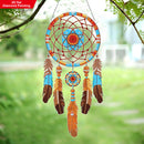 Decorative dreamcatcher with feathers hanging outdoors