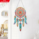 Colorful dreamcatcher wall decoration on a white wall with a chair and table in the background.