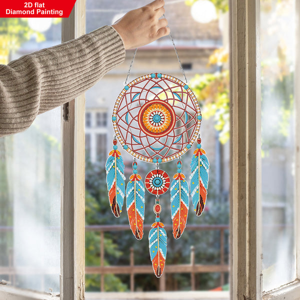Colorful dreamcatcher hanging by a window with a blurred outdoor background
