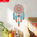 Decorative dreamcatcher with colorful feathers hanging on a wall.