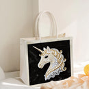 Tote bag with a unicorn design on a black background