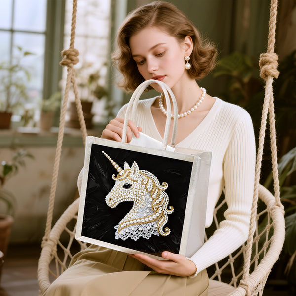 Woman holding a tote bag with a unicorn design in an indoor setting