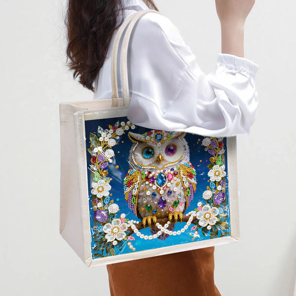 Tote bag with a decorative owl design held by a person