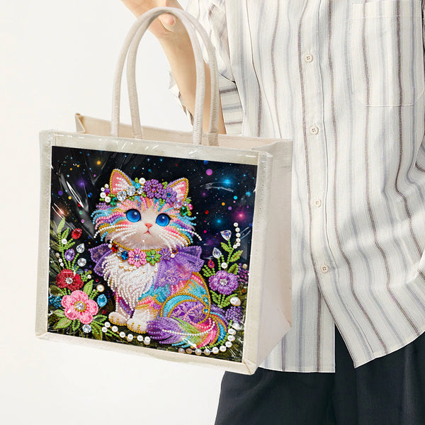 Tote bag with a colorful cat design held by a person wearing a striped shirt.