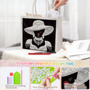 Pearl-decorated canvas bag with diamond art design, surrounded by tools and materials.