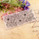Floral stamp on a textured surface with flowers in the background