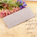 Decorative embossed card on a textured surface with flowers