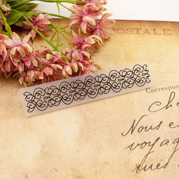 Decorative metal bookmark on an old letter with pink flowers