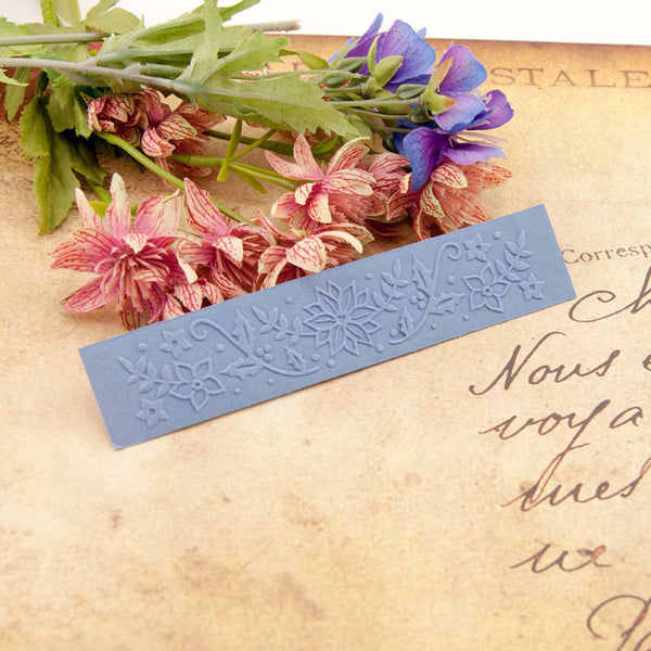 Decorative blue stamp with floral design on an old letter with flowers