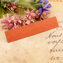 Orange leather bookmark with floral design on a vintage paper background
