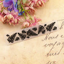 Decorative stencil with leaf pattern on a textured surface with flowers