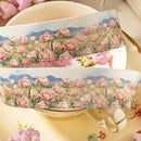 Two rolls of floral tape with pink flowers and blue sky on a white background.