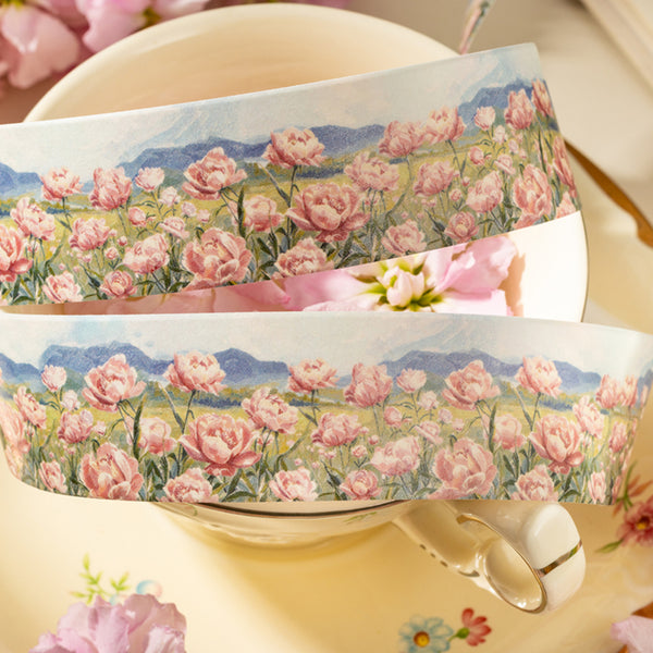 Two rolls of floral tape with pink flowers and blue sky on a white background.