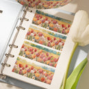 Notebook with floral design pages and a tulip on a white background
