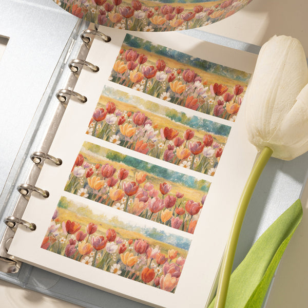 Notebook with floral design pages and a tulip on a white background