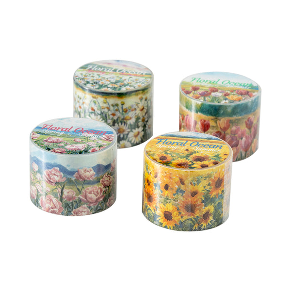 Four cylindrical containers with floral designs on lids against a white background