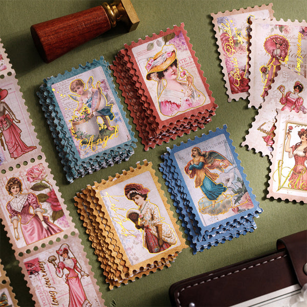 Collection of vintage-style postage stamps with intricate designs on a green surface.