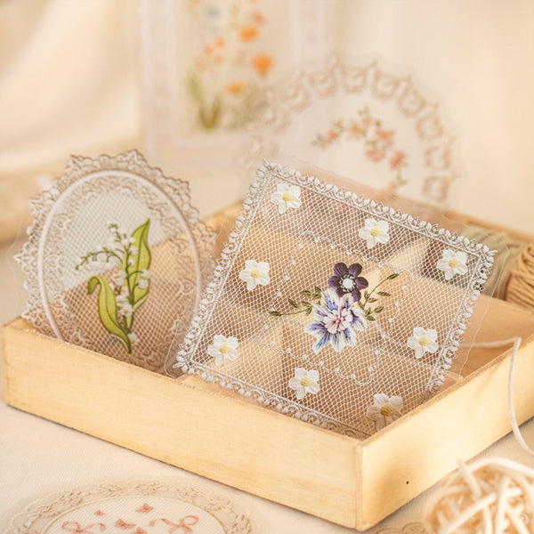Decorative lace doilies with floral designs in a wooden box.