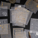 Collection of vintage-style cards with gold and black text on a dark surface