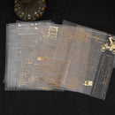 Translucent sheets with gold text and designs on a black background
