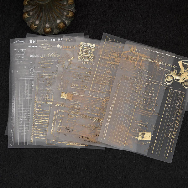 Translucent sheets with gold text and designs on a black background