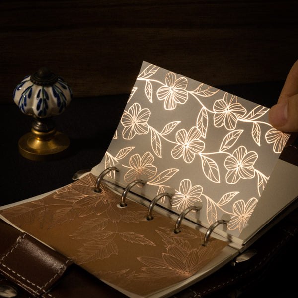 Floral-patterned notebook with a dark background