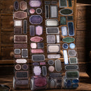 Collection of decorative labels on a wooden surface