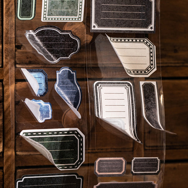 Collection of decorative paper labels on a wooden surface