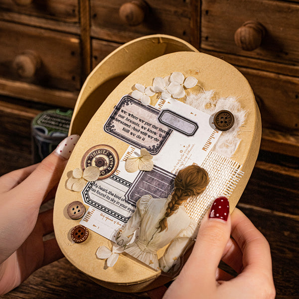 Heart-shaped wooden box with decorative elements held by a person against a wooden background.