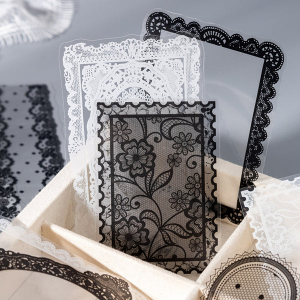 Black lace card with floral design on a gray background