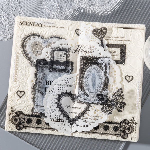 Decorative paper with lace, hearts, and text on a textured surface