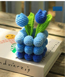 Crocheted blue and green flowers on a book