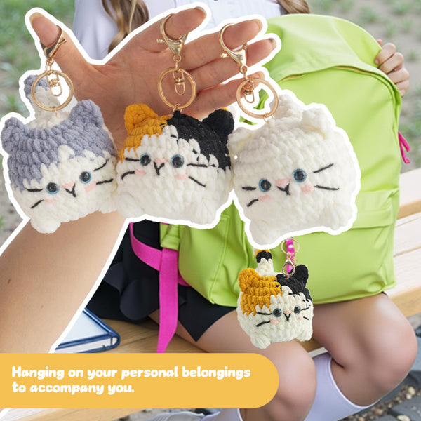 Four cat-shaped keychains hanging from a bag with text 'Hanging on your personal belongings to accompany you.'