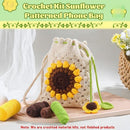 Crocheted sunflower-patterned phone bag with yarn on a wooden surface