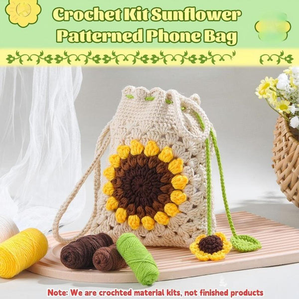 Crocheted sunflower-patterned phone bag with yarn on a wooden surface
