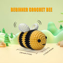 Crocheted bee toy with measurements and a nature-themed background