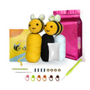 Crochet bee kit with yarn, hooks, and packaging on a white background