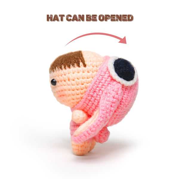 Crocheted character with an open hat on a white background