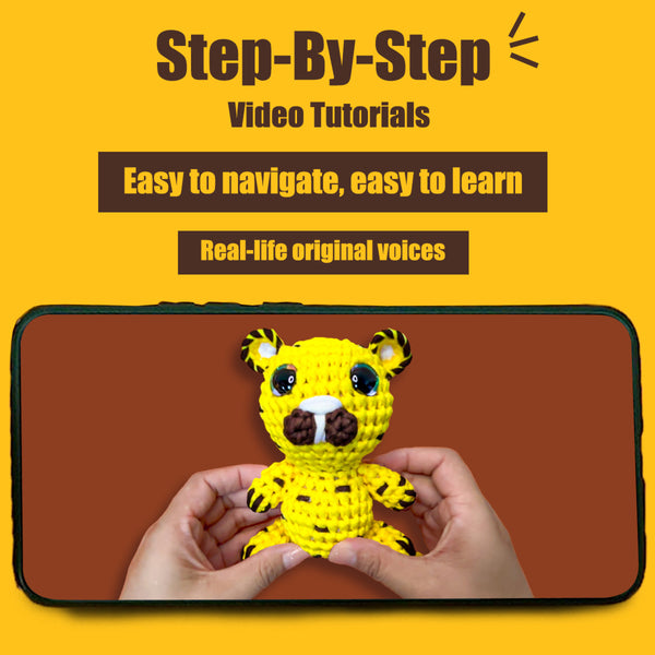 Phone screen showing a yellow crocheted tiger toy held by hands with promotional text about step-by-step video tutorials.