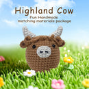 Crocheted Highland cow toy in a grassy field with flowers and a blue sky.