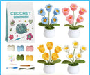 Crocheted flowers in pots with a 'Crochet for Beginners' book and yarn balls on a blue background.