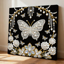 Decorative wall art with a butterfly and floral design on a black background
